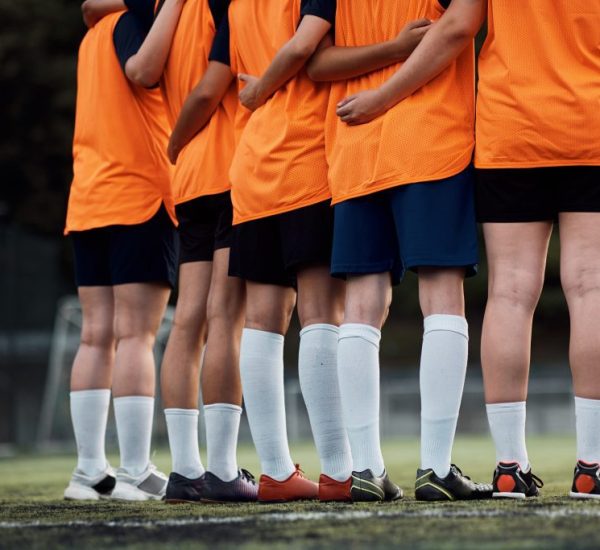 Unrecognizable female soccer players standing embraced at the stadium. Unrecognizable female soccer players standing embraced at the stadium.